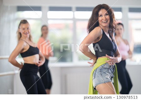 Adult woman dancing high heels in group 130978513
