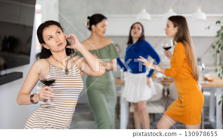Smiling women dancing at a bachelorette party - girlfriends home party 130978655