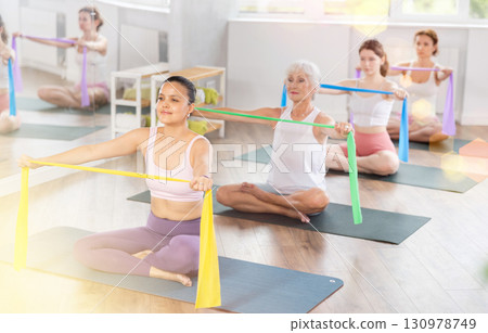 Young woman exercising with pilates band 130978749