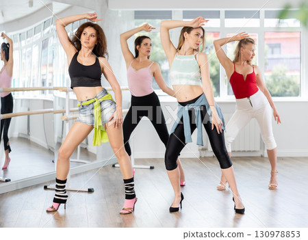 Graceful women fusing sensuality and style in high heel dance class 130978853