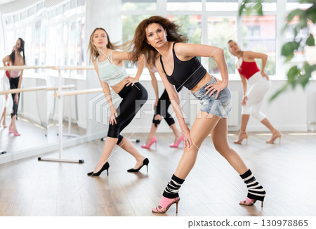 Group of women dancing high heels in studio Group of women dancing high heels in studio 130978865