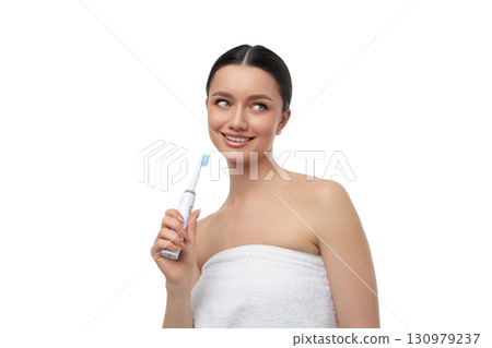 Young woman loves using her electric toothbrush, isolated, PNG 130979237