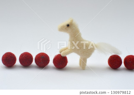 Wool felt horse and red felt ball Wool felt horse and red felt ball 130979812