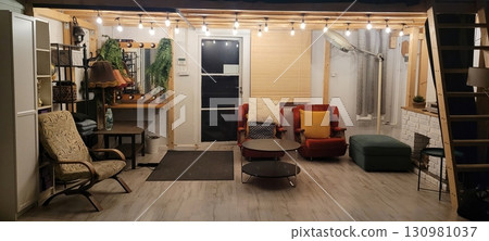 Stylish and Cozy Modern Living Room Featuring Unique Furniture Along with Elegant Lighting 130981037