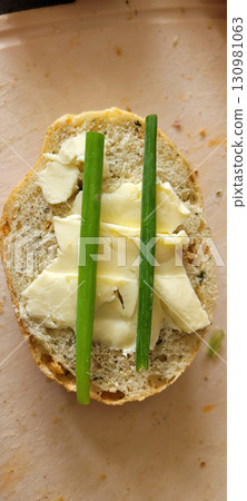 Enjoy a tasty OpenFaced Sandwich with Cheese and Fresh Green Onions for a delightful meal 130981063