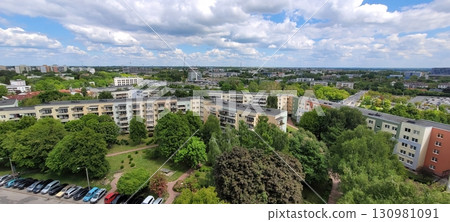 A beautiful, scenic urban landscape showcasing lush greenery alongside striking modern architecture 130981091