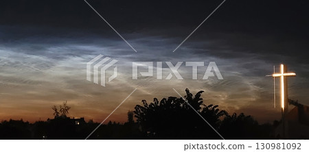 A Beautiful Serene Sunset with an Illuminated Cross Set Against a Cloudy Sky Landscape A Beautiful Serene Sunset with an Illuminated Cross Set Against a Cloudy Sky Landscape 130981092