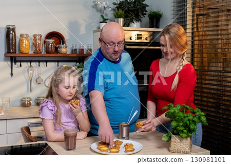 The Joy of Cooking Together as a Family in a Cozy and Inviting Kitchen Setting for Everyone The Joy of Cooking Together as a Family in a Cozy and Inviting Kitchen Setting for Everyone 130981101