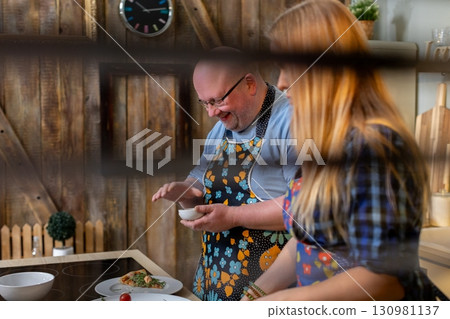 Joyful Cooking Together in a Beautiful and Rustic Kitchen Setting with Loved Ones and Friends Joyful Cooking Together in a Beautiful and Rustic Kitchen Setting with Loved Ones and Friends 130981137