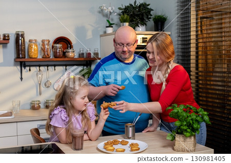 Family Members Delight in the Joys of Cooking Together in a Warm and Inviting Kitchen Setting 130981405