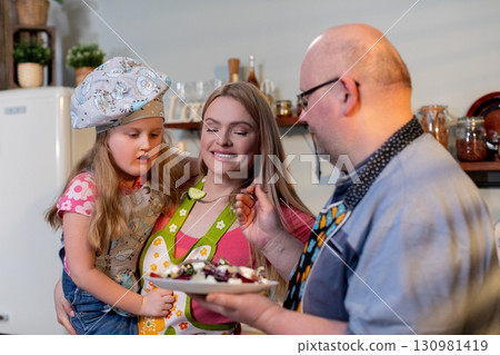 Experience the joy of family baking in the kitchen, creating delicious treats together 130981419