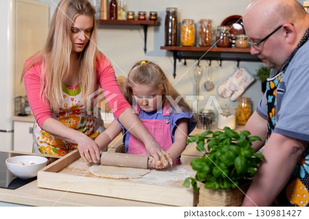 Enjoying Family Cooking Together in the Kitchen, Creating Memorable Experiences and Joy Enjoying Family Cooking Together in the Kitchen, Creating Memorable Experiences and Joy 130981427