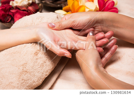 A young Asian woman is getting a hand massage. 130981634
