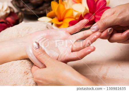 A young Asian woman is getting a hand massage. 130981635