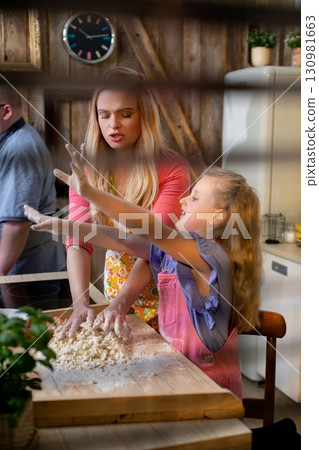 Cooking Together A Child and Parent in the Kitchen, Creating Delicious Memories Side by Side Cooking Together A Child and Parent in the Kitchen, Creating Delicious Memories Side by Side 130981663