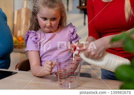 Children are Learning Valuable Cooking Skills with Active Guidance from Their Parents 130981678