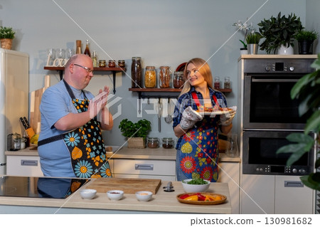 Chefs are joyfully Celebrating Culinary Creations together in a Stylish Kitchen Space 130981682