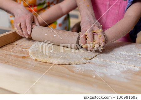 Baking Together An Enjoyable Family Activity That Involves Rolling Dough Together Baking Together An Enjoyable Family Activity That Involves Rolling Dough Together 130981692