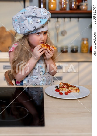 A Young Chef Joyfully Enjoying the Process of Making Homemade Pizza in the Kitchen A Young Chef Joyfully Enjoying the Process of Making Homemade Pizza in the Kitchen 130981704