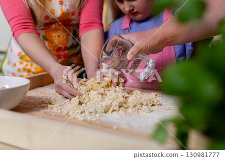 A Family Enjoys Baking Together in the Kitchen, Creating Memories and Delicious Treats A Family Enjoys Baking Together in the Kitchen, Creating Memories and Delicious Treats 130981777