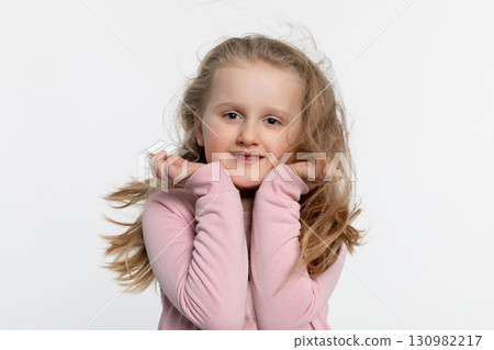 A Cheerful Happy Child Smiling Brightly While in a Playful and Joyful Pose, Radiating Happiness A Cheerful Happy Child Smiling Brightly While in a Playful and Joyful Pose, Radiating Happiness 130982217