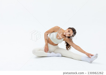 An Elegant Stretching Pose in a Minimalist Setting that embodies grace and calmness 130982262