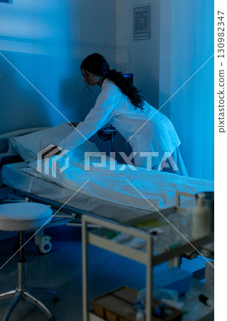 A Healthcare Professional Providing Compassionate Care to a Patient within a Hospital Setting A Healthcare Professional Providing Compassionate Care to a Patient within a Hospital Setting 130982347