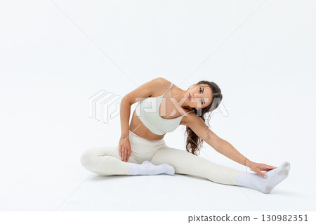 A Graceful Stretching Pose Presented in a Minimalist Fashion with Artistic Flair and Elegance A Graceful Stretching Pose Presented in a Minimalist Fashion with Artistic Flair and Elegance 130982351