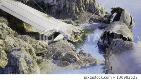 A damaged aircraft rests on a rocky shoreline, partially submerged in calm waters. Surrounding cliffs provide a rugged backdrop. The scene conveys a sense of abandonment and decay. A damaged aircraft rests on a rocky shoreline, partially submerged in calm waters. Surrounding cliffs provide a rugged backdrop. The scene conveys a sense of abandonment and decay. 130982522