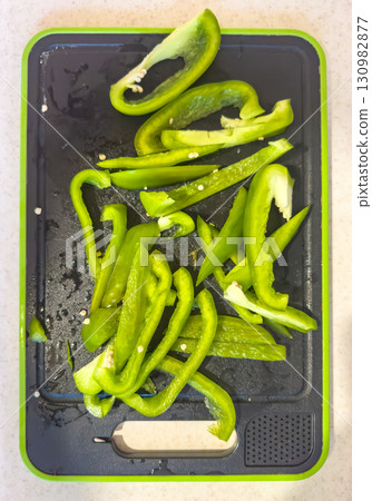 Sliced green bell peppers on a cutting board Sliced green bell peppers on a cutting board 130982877