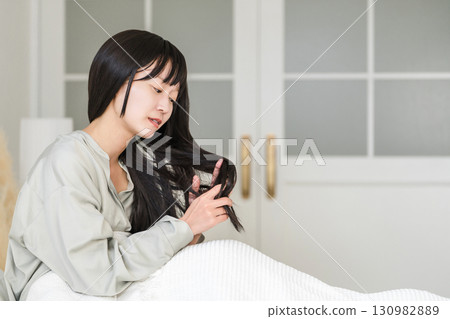 Women who suffer from dry, damaged hair caused by friction from pillows and tangled hair caused by turning over in bed 130982889