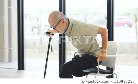Elderly Asian man standing up with a cane Elderly Asian man standing up with a cane 130983255