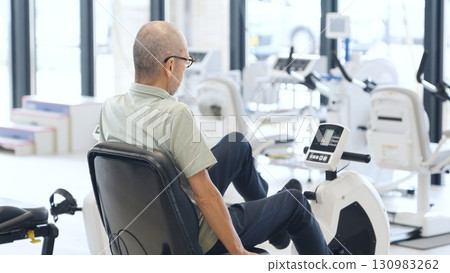 Asian elderly people exercising on recumbent bikes Asian elderly people exercising on recumbent bikes 130983262