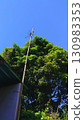 Old Simple TV Antenna Against Bright Blue Sky.  130983353