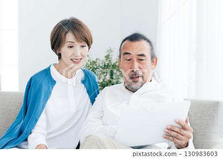Senior couple looking at laptop 130983603