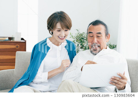 Senior couple looking at laptop 130983604