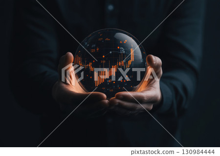 Hands holding a glowing sphere with graphs of supply and demand interacting, representing the core of market economics, market forces, economic balance 130984444