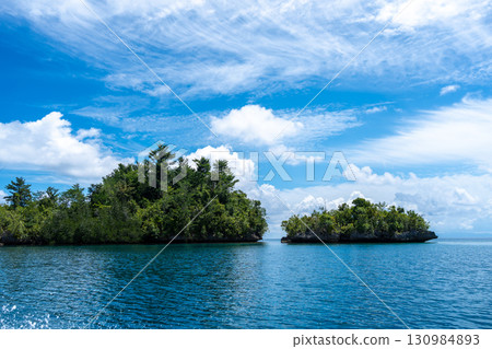 Rocky islets under blue sky, Togian Islands, Sulawesi, Indonesia 130984893