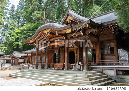 Sakurayama Hachimangu Shrine buildings surrounded by tall trees in Takayama, Japan Sakurayama Hachimangu Shrine buildings surrounded by tall trees in Takayama, Japan 130984898
