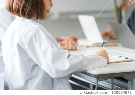 Medical conference, study group, seminar, medical staff in white coats receiving training, medical professionals, doctors Medical conference, study group, seminar, medical staff in white coats receiving training, medical professionals, doctors 130984971