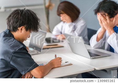 Male nurse, doctor, physician depressed by medical malpractice trouble (shock, anguish, despair) 130985161