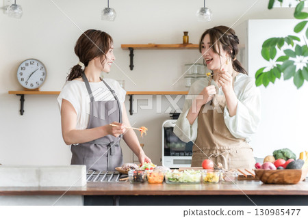A female instructor and a female student at a cooking class/cooking school (tasting) A female instructor and a female student at a cooking class/cooking school (tasting) 130985477
