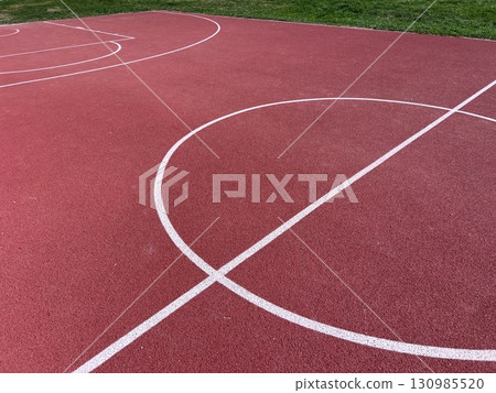 A multipurpose playground with rubber coating and markings for tennis, basketball and volleyball. 130985520