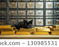 Gold bars in bank safe deposit box room with black cat close up 130985531