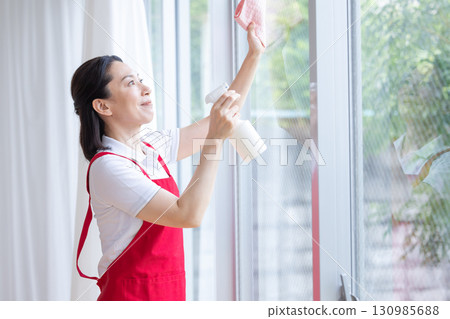 Cleaning, housekeeping, middle-aged woman cleaning Cleaning, housekeeping, middle-aged woman cleaning 130985688