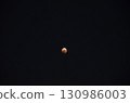 Lunar eclipse in the night sky 130986003