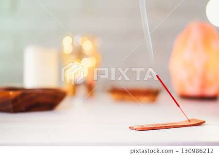 Burning scented stick burning on table Burning scented stick burning on table 130986212