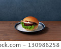 Teriyaki burger on a plate on a wooden table 130986258
