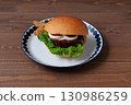 Teriyaki burger on a plate on a wooden table 130986259