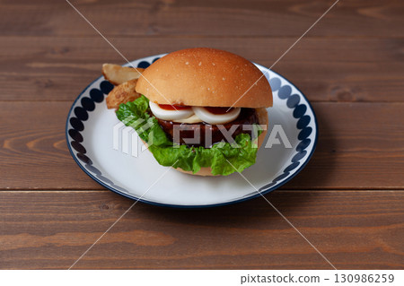 Teriyaki burger on a plate on a wooden table 130986259